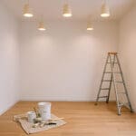 How to plan an interior painting project with a prepared room, paint supplies, and ladder ready for professional interior painting work